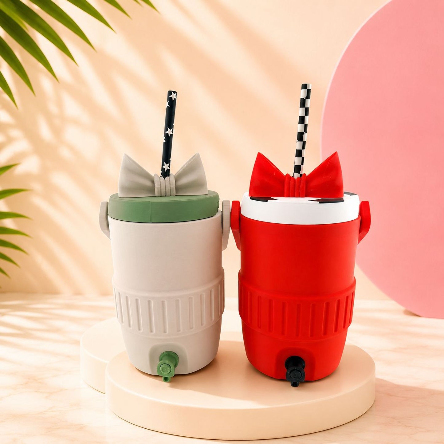 Two colorful drink containers with straws, one white and one red, are placed on a white pedestal against a pink background.