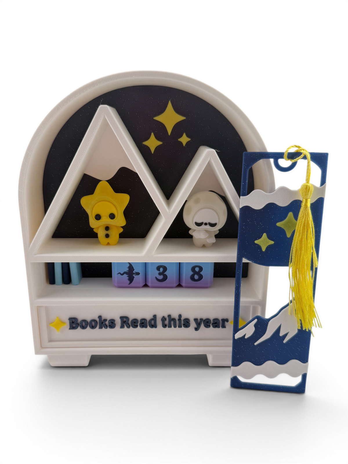 A bookshelf with a tassel and a small figurine, along with a book-related item, all set against a starry night sky background.
