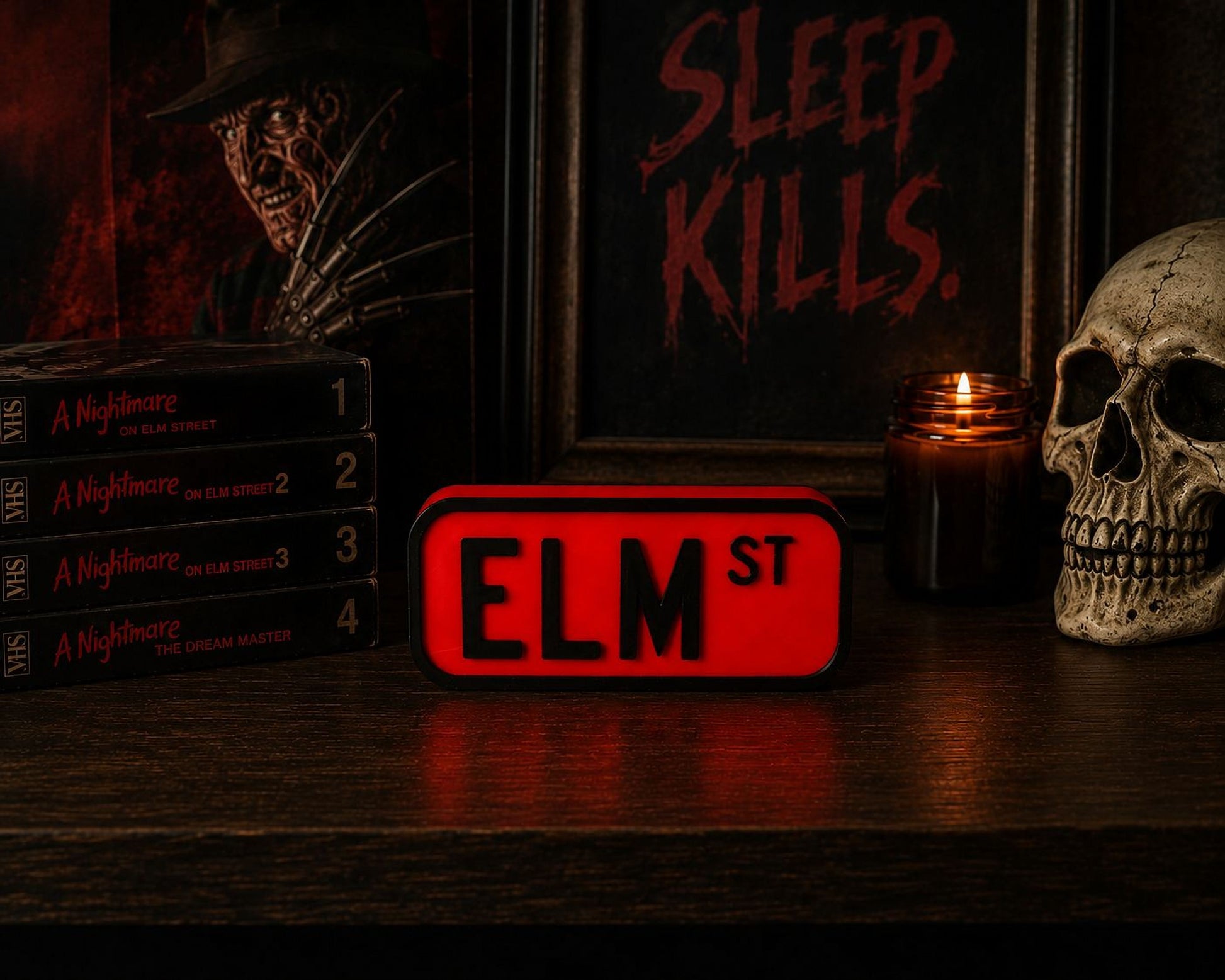 a collection of horror movie posters and memorabilia, including a skull, a red sign with the letters "ELM ST", and a stack of horror movie DVDs.