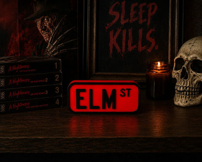 a collection of horror movie posters and memorabilia, including a skull, a red sign with the letters "ELM ST", and a stack of horror movie DVDs.
