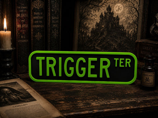 a sign that says "TRIGGER TER" in green letters, surrounded by various books, a candle, and a bottle of what appears to be a mysterious liquid.