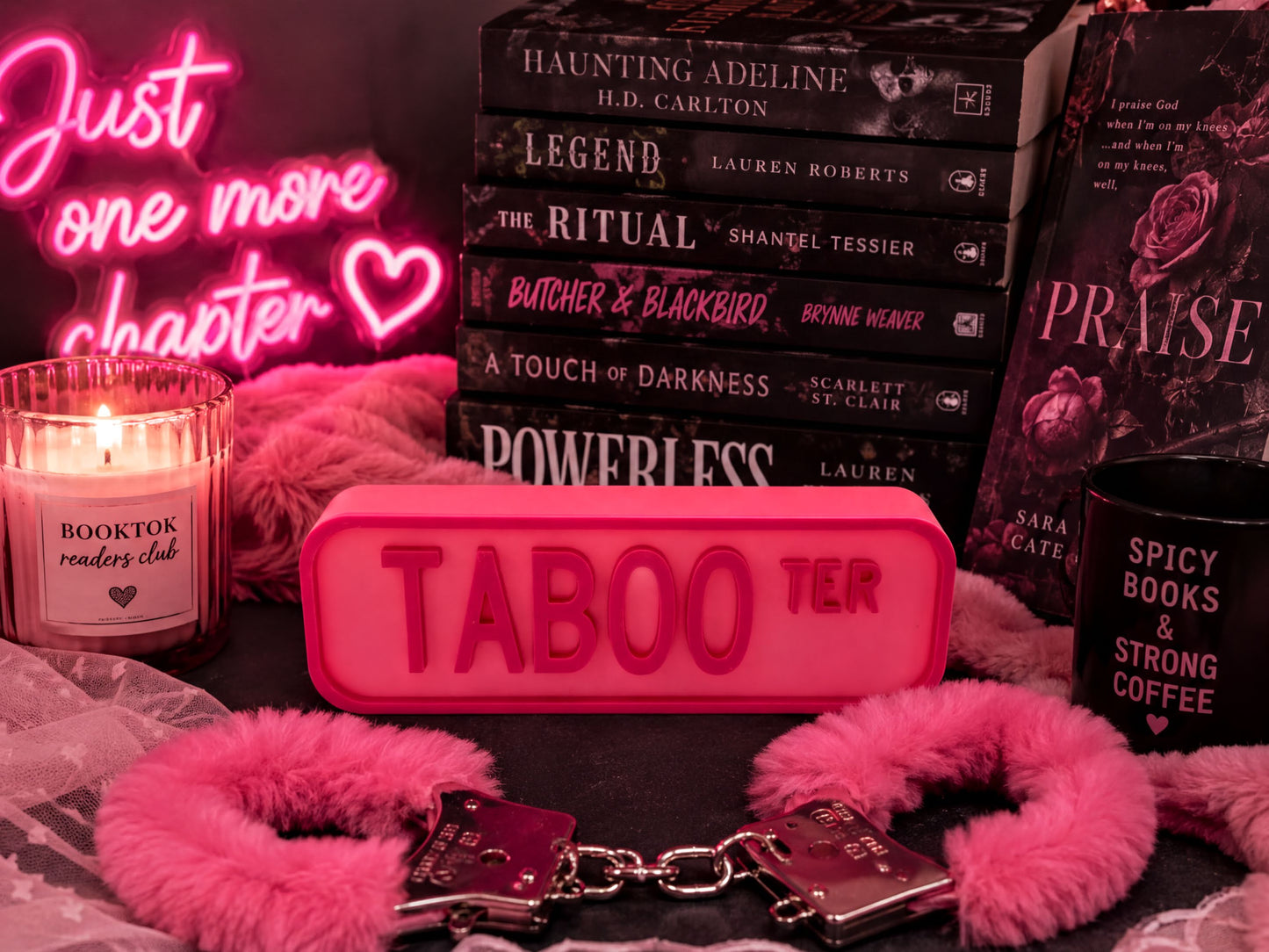 a collection of books, a candle, and some accessories, all arranged in a visually appealing manner.