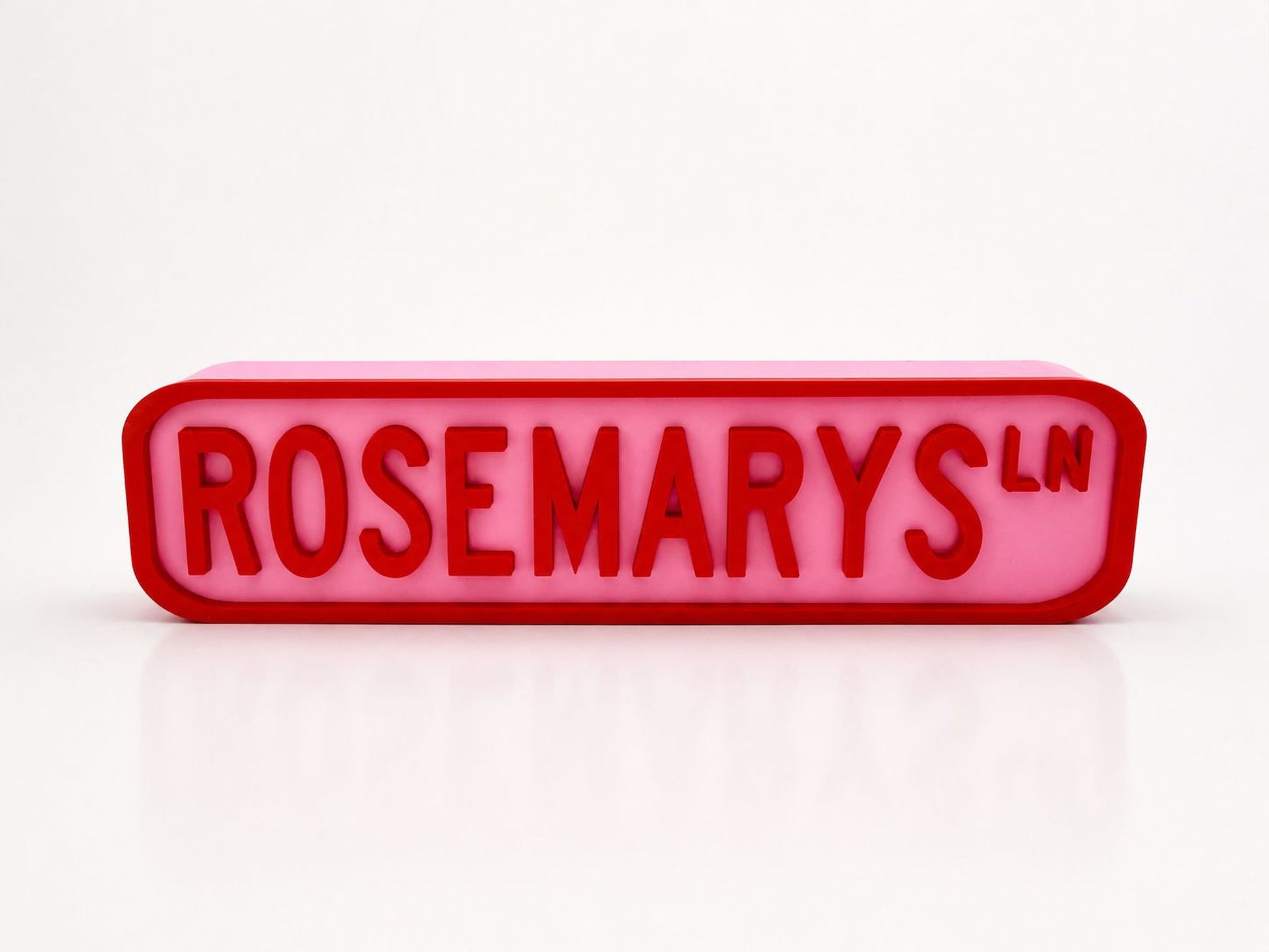 A pink rectangular sign with the word "ROSEMARYS" in red letters.