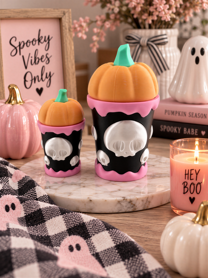 Halloween decorations, including two small pumpkins with skull faces, a candle, and a framed sign that says "Spooky Vibes Only".