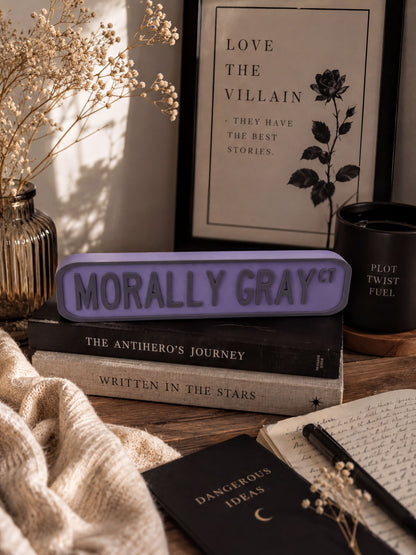 a collection of books, a framed quote, and some decorative elements arranged on a wooden surface.