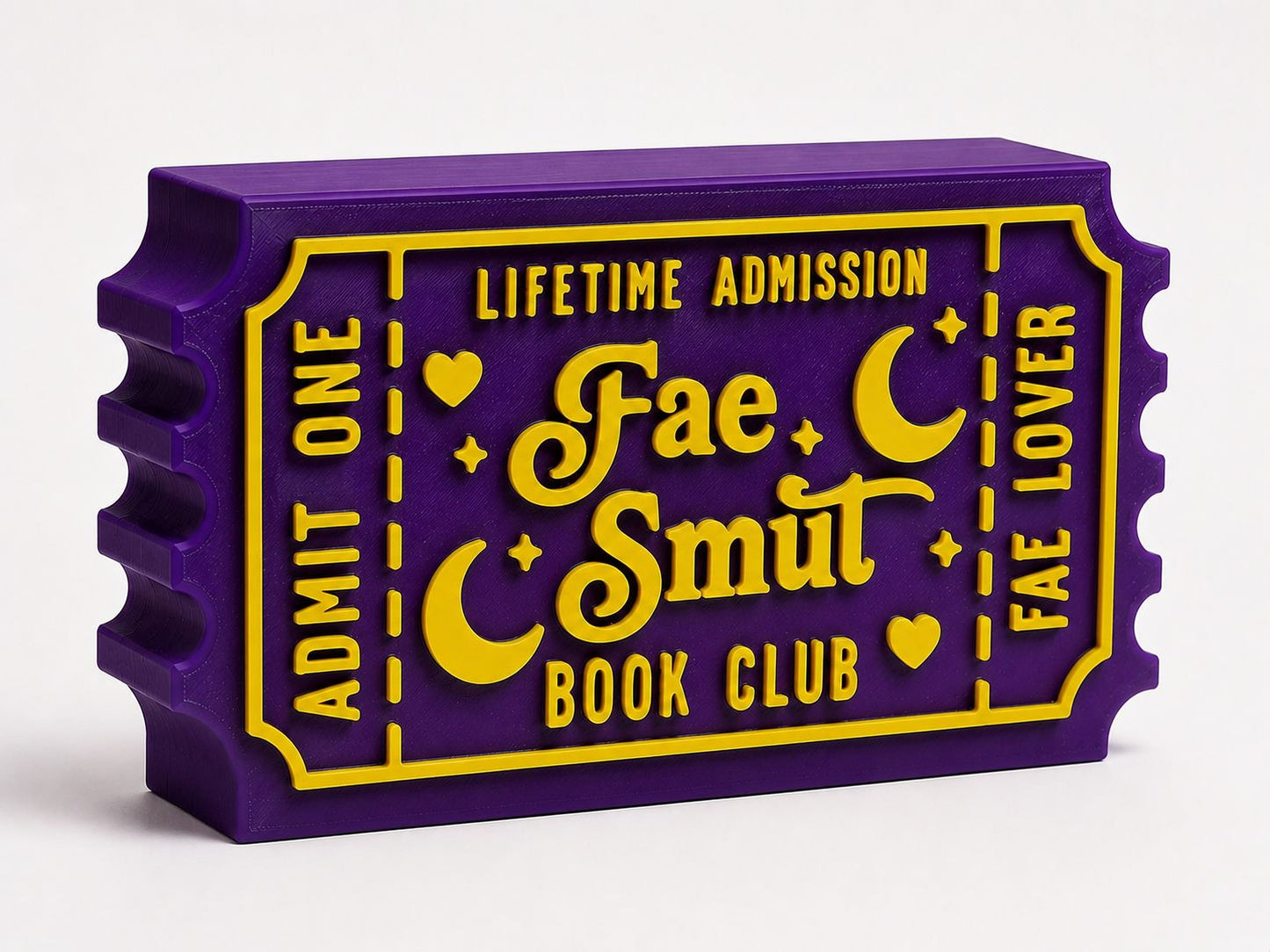 A purple and yellow ticket-shaped object with text that reads "Lifetime Admission Fae Smut Book Club".