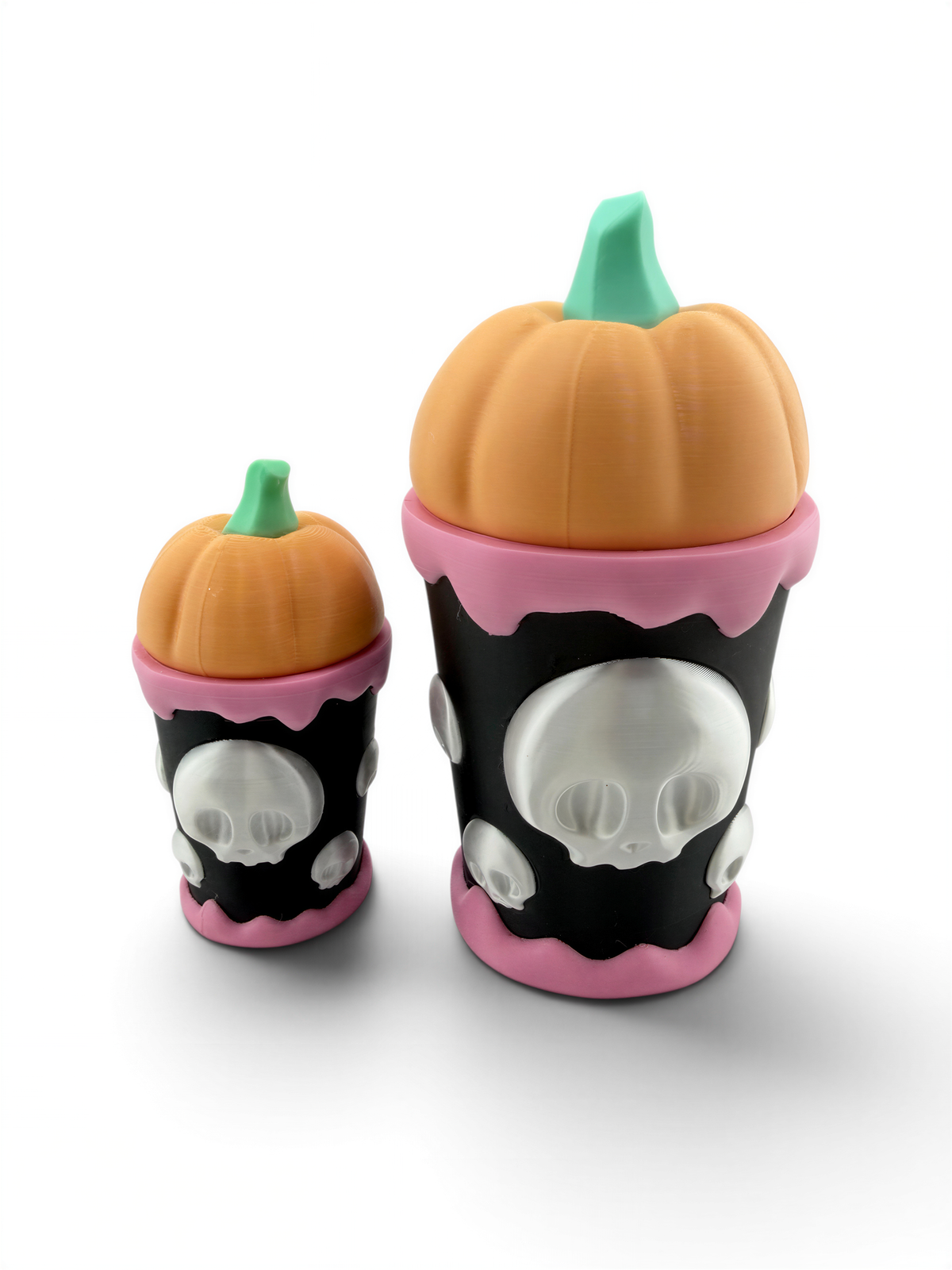 two small, colorful cups with skull designs on them.