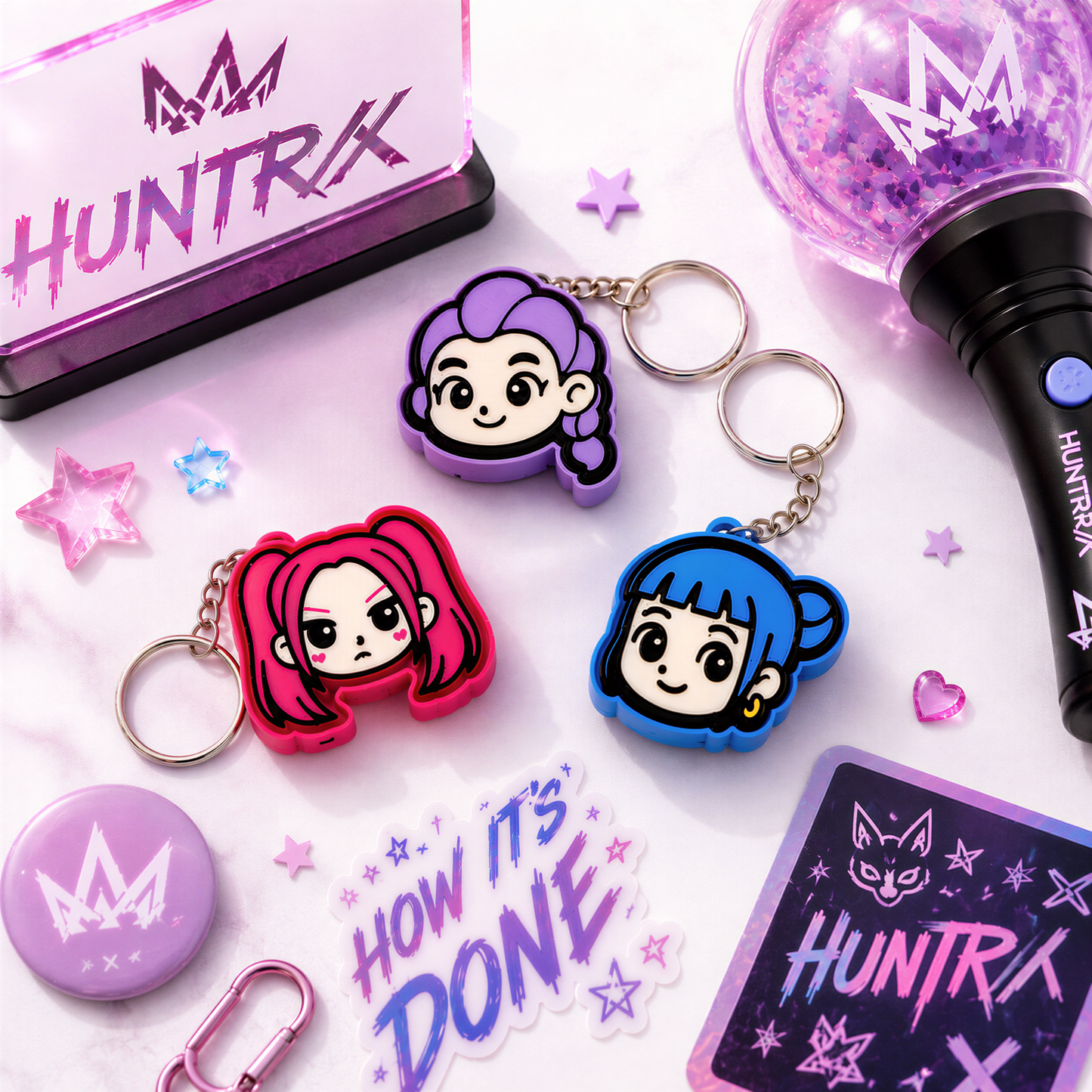 various colorful keychains, a glittery object, and some decorative elements, all arranged on a white background.