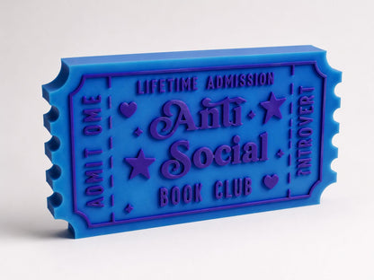 A blue ticket-shaped object with text on it, which appears to be a promotional item or merchandise related to a book club or social event.