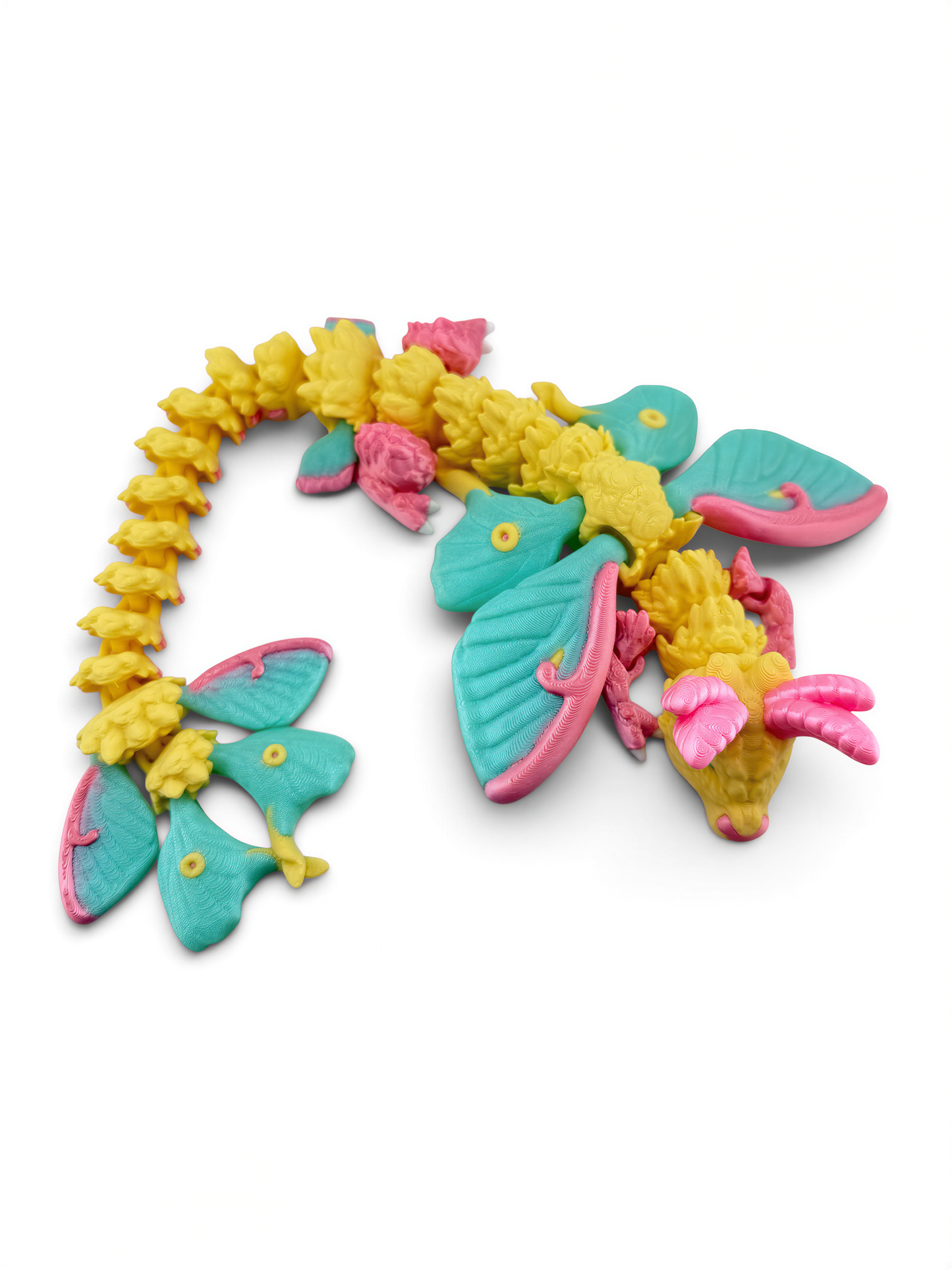 A colorful toy dragon made of plastic, featuring a combination of yellow, pink, and blue colors.