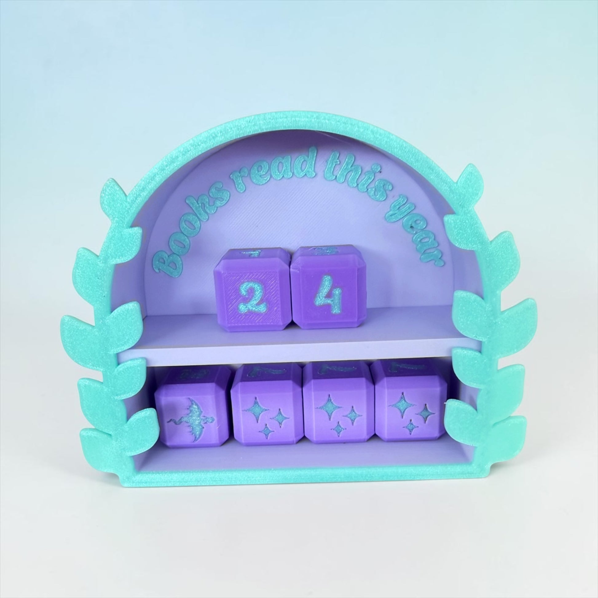 A purple and green shelf with purple cubes and leaves, displaying the text "Books read this year" and numbers 2 and 4.