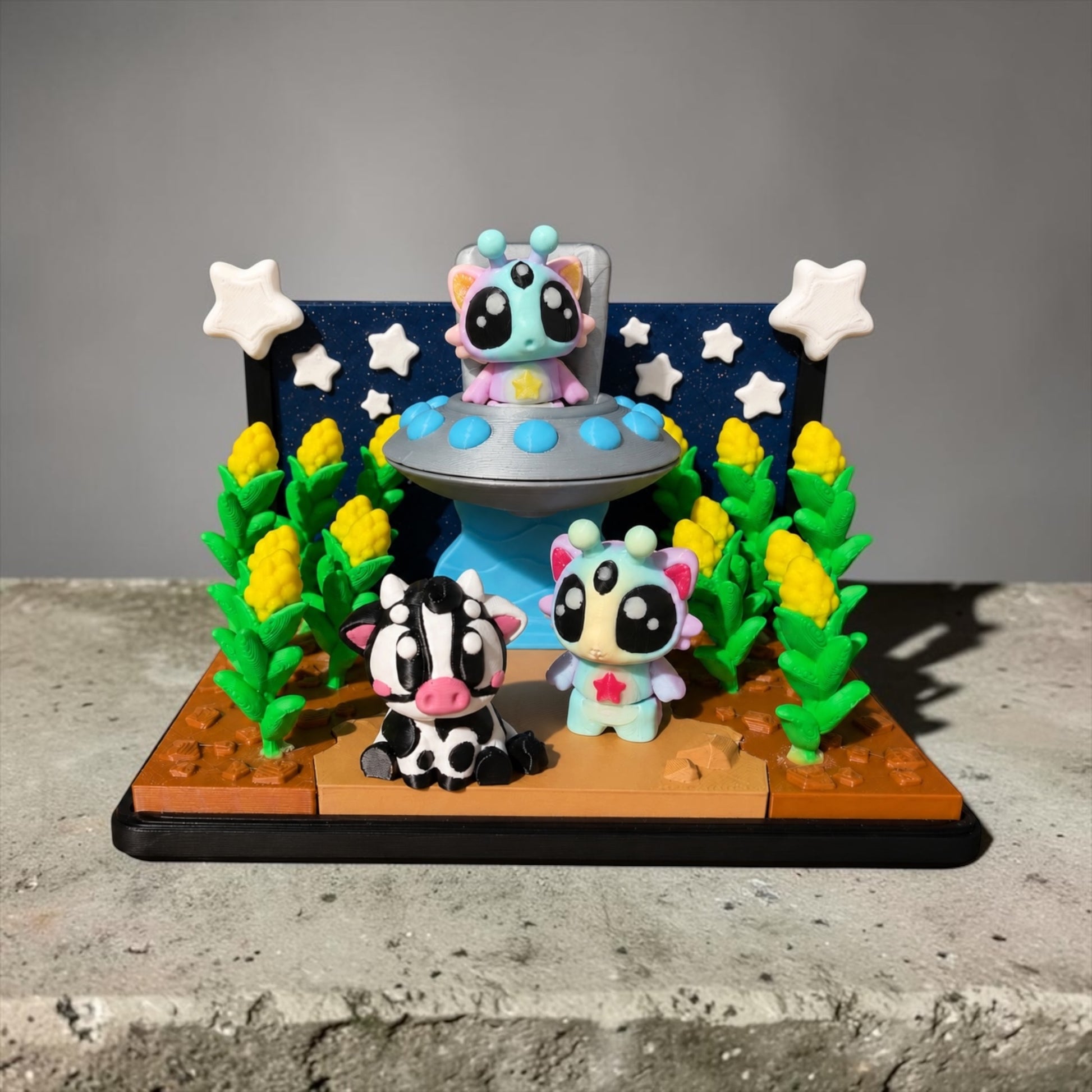 A whimsical scene featuring three small, colorful figurines of animals, including a cow, a cat, and a bird, set against a backdrop of a spaceship and stars.