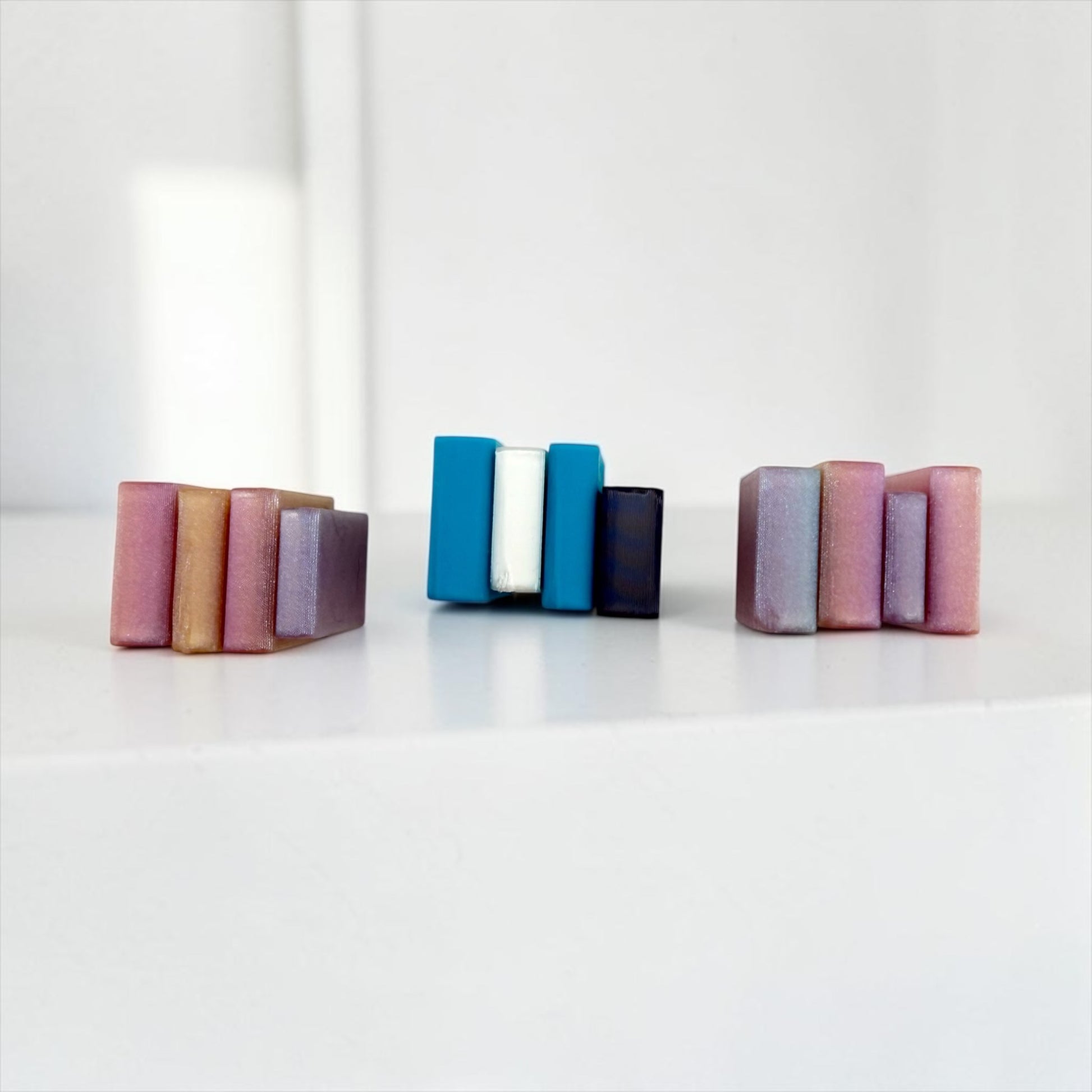 Three colorful blocks of varying sizes are arranged on a white surface.