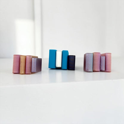 Three colorful blocks of varying sizes are arranged on a white surface.