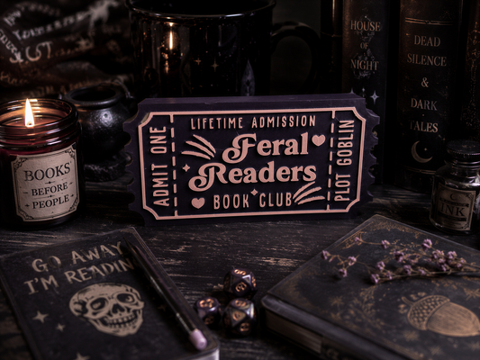 a dark and moody scene with various objects, including a book, a candle, a ticket, and some dice. The objects are arranged in a way that suggests a connection between them, possibly as part of a story or narrative.