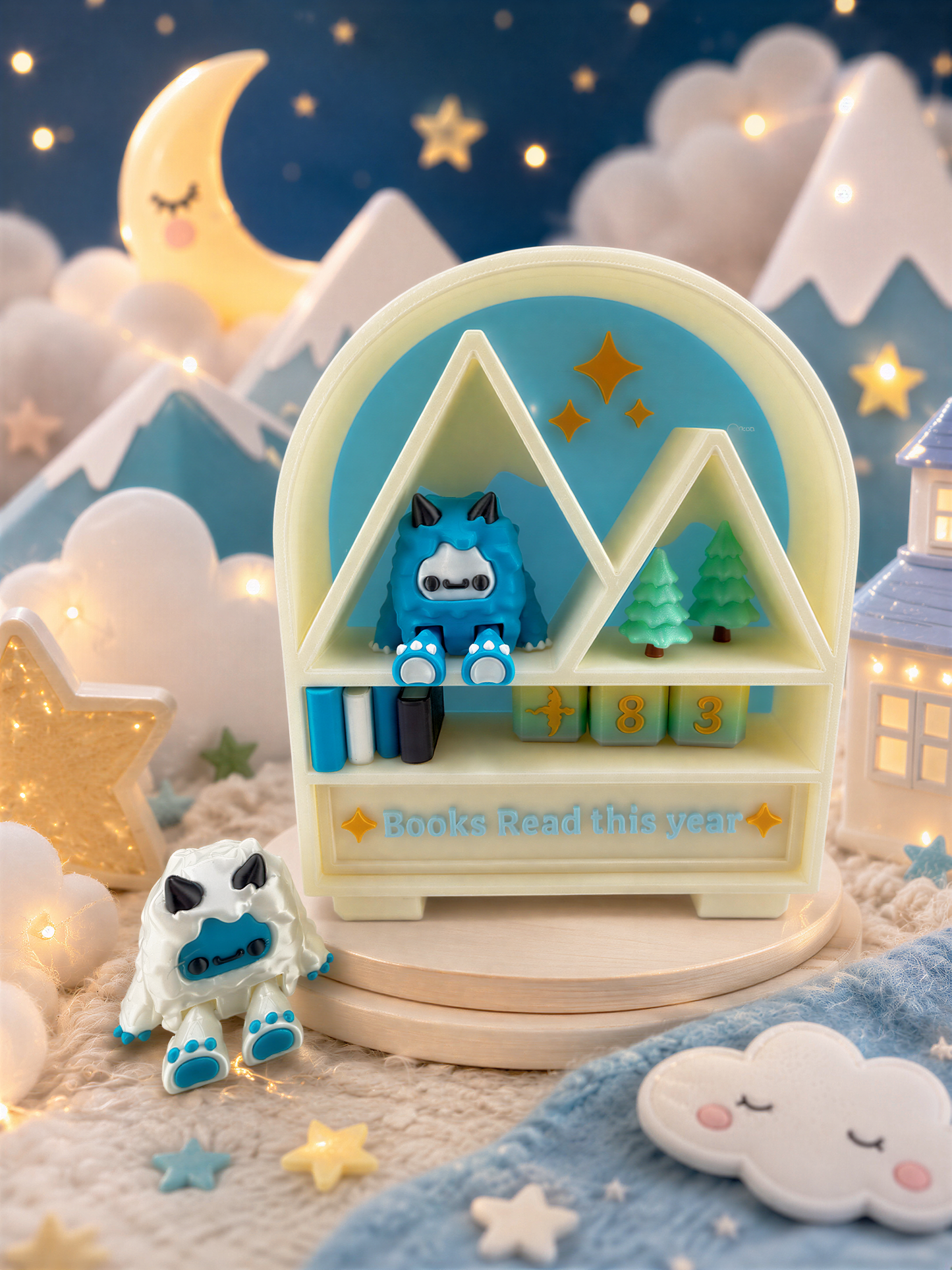 A whimsical scene featuring a toy bookshelf with a blue monster figurine, surrounded by stars, clouds, and mountains. The bookshelf is decorated with a sign that says "Books Read this year".