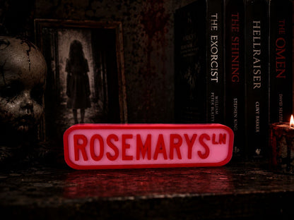 a red sign with the word "ROSEMARYS" on it, surrounded by a dark, spooky atmosphere with a creepy doll and a lit candle.