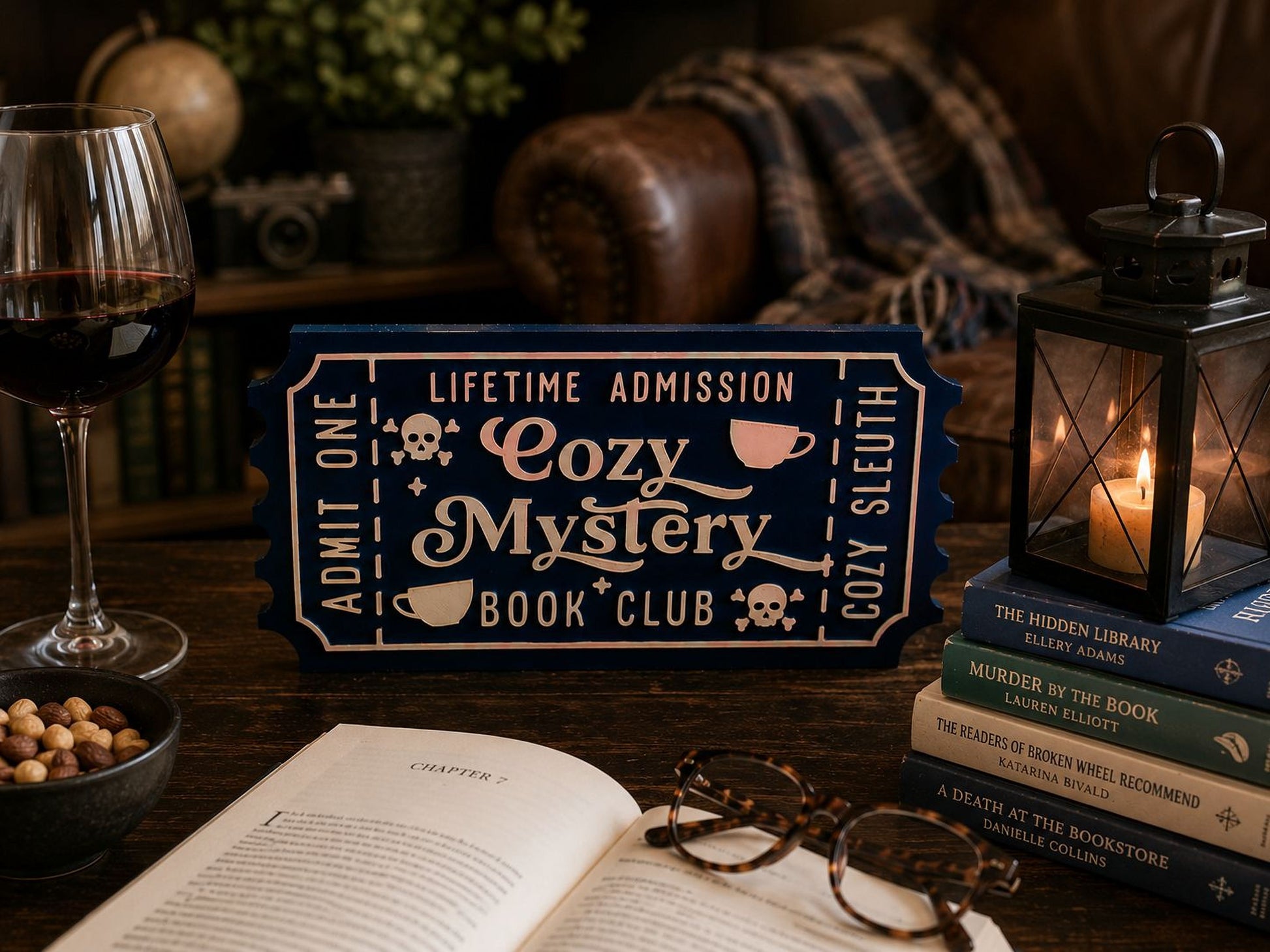a cozy atmosphere with a book club sign, a glass of wine, a stack of books, a lantern, and a bowl of nuts on a wooden table.