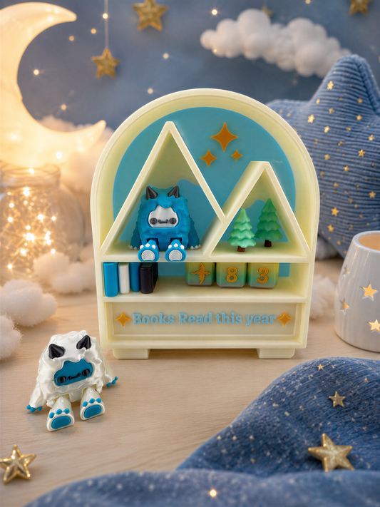 A whimsical toy display featuring a blue monster, a white monster, and a small toy car, set against a starry night sky background with a crescent moon.