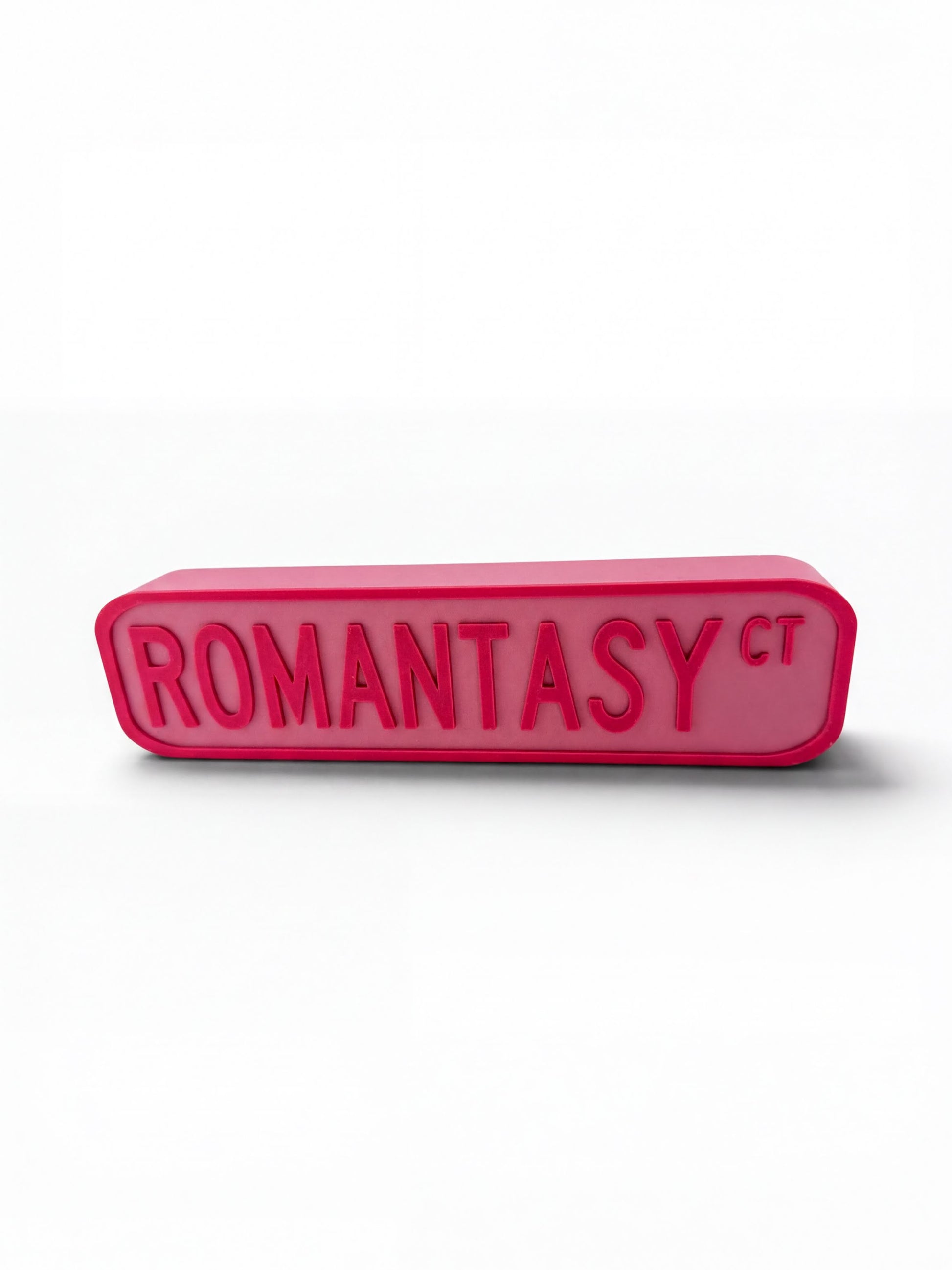A pink rectangular object with the text "ROMANTASY" in large, bold letters.