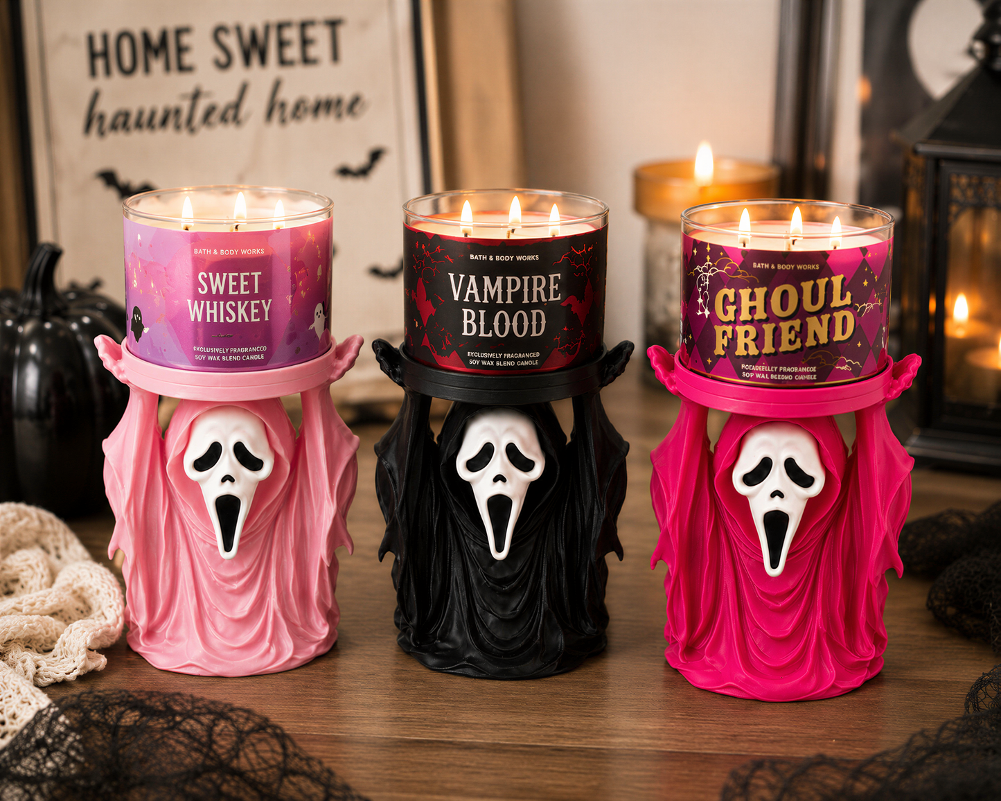 Three Halloween-themed candles in the shape of ghostly figures, each with a different color and label, are displayed on a wooden surface.